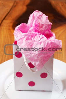 Pink polka-dot colored gift bag
