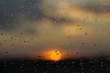 sunset through window with raindrops