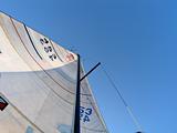 Shot of full sail and mast against clear blue sky