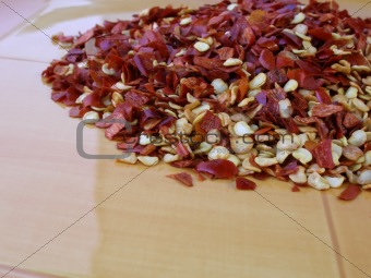 Red chili seeds and skin on yellow plate