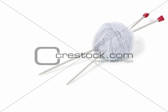 Grey woolen mohair clew with knitting needles