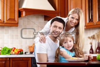 Parents with the child on kitchen
