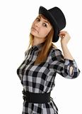 Beautiful young woman in black hat posing on white