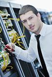 young engeneer in datacenter server room