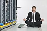 business man practice yoga at network server room
