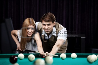 Happy couple in a billiard room
