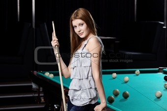 The girl at a billiard table