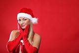 Young girl dressed as Santa Claus on a red background