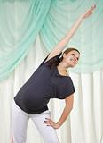 Young pregnant woman doing exercises 