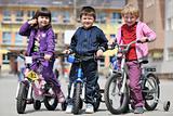 happy childrens group learning to drive bicycle