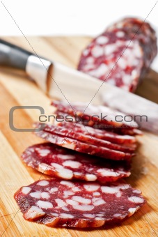 Salami sliced on chopping board