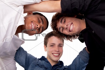 three young man of different colors,looking to camera and smiling, view from below
