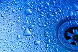 Blue drops of water on metal