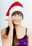 happy smiling girl with Santa hat with a phone