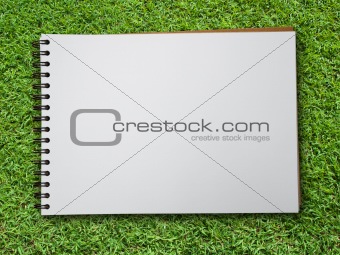 note book on green grass