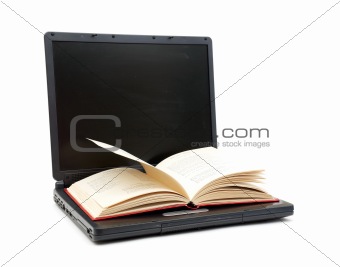 The Open Book Laying On The Laptop