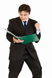 Pleased modern businessman looking  in folder with documents
