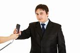 Smiling young businessman taking phone from secretary
