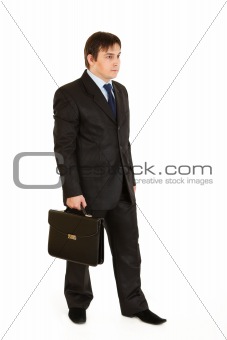 Full length portrait of young businessman holding  briefcase in hand
