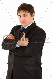 Confident young businessman showing  thumb up gesture. Concept - confidence and reliability
