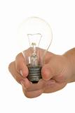 Hand holds incandescent lamp
