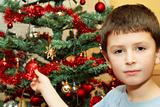 Young boy holding Christmas decorations