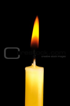 Yellow  candle in dark room