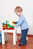 Lovely boy playing with blocks
