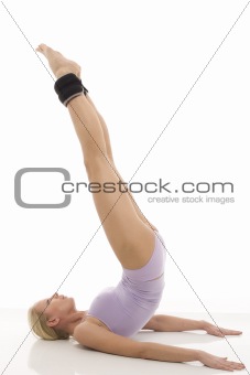 portrait of a young caucasian woman does gymnastics with ankle weights