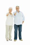 happy elderly couple with a thumbs-up