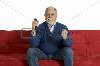 old man on the sofa with television remote control