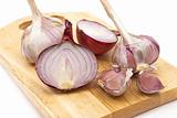 Garlic and onion on a wooden plate 