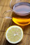 Glass cup of tea with lemon