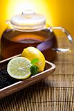 Glass teapot of tea with lemon