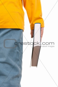 Teenager holds book in hand
