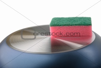 Sponge for ware lies on turned frying pan