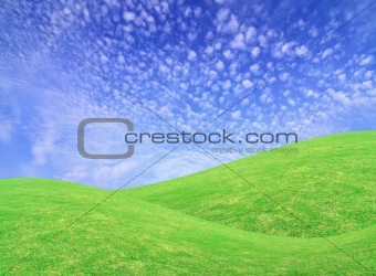 clouds on blue sky above green meadow 
