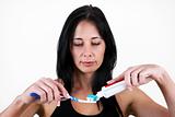 Woman putting toothpaste onto toothbrush