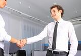 Business man shaking hands with a woman in the office 