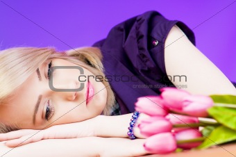 Young girl with tulips against colourful background