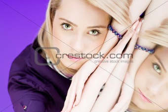 Attractive blond girl against colourful background