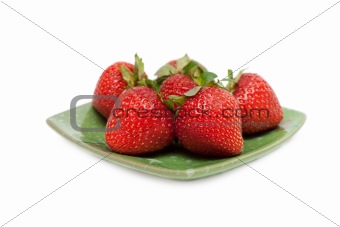 Strawberries on green chinese saucer