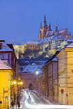 prague in winter - hradcany castle and traffic at mala strana  at dusk