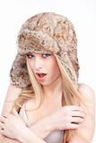 beautiful blond girl with blue eyes in fur hat - isolated on white
