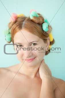 Pretty woman with hair rollers