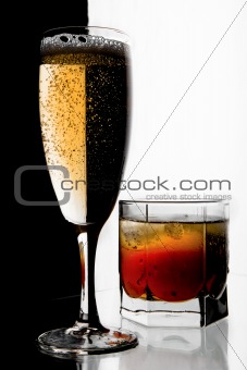 Glass of champagne and whisky with ice.