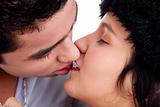 close up, portrait of young couple kissing, isolated on white, studio shot