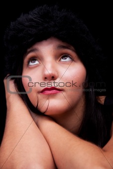 thoughtful and beautiful woman, looking up , isolated on black background. Studio shot.