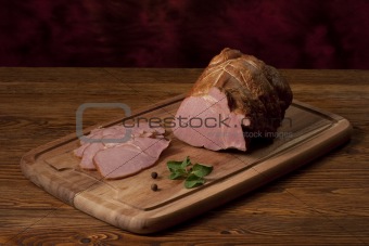 Composition with smoked ham on the table