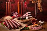 A composition of different sorts of sausages on the table
